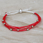 Used with cord to make a sliding knot closure