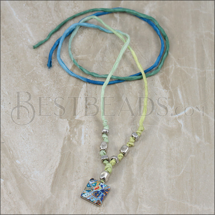 Sample used as a necklace, knotted and with beads