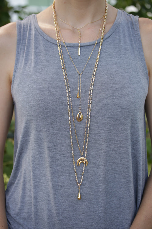 Hanging from second necklace